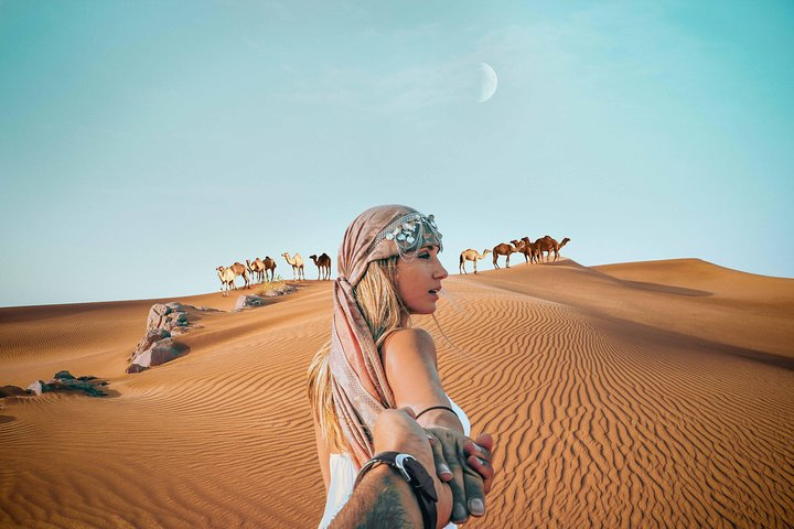 Experience the stunning expanse of Dubai's red golden desert where genuine Arab hospitality meets rich culture and heritage creating unforgettable moments under the vast desert sky.